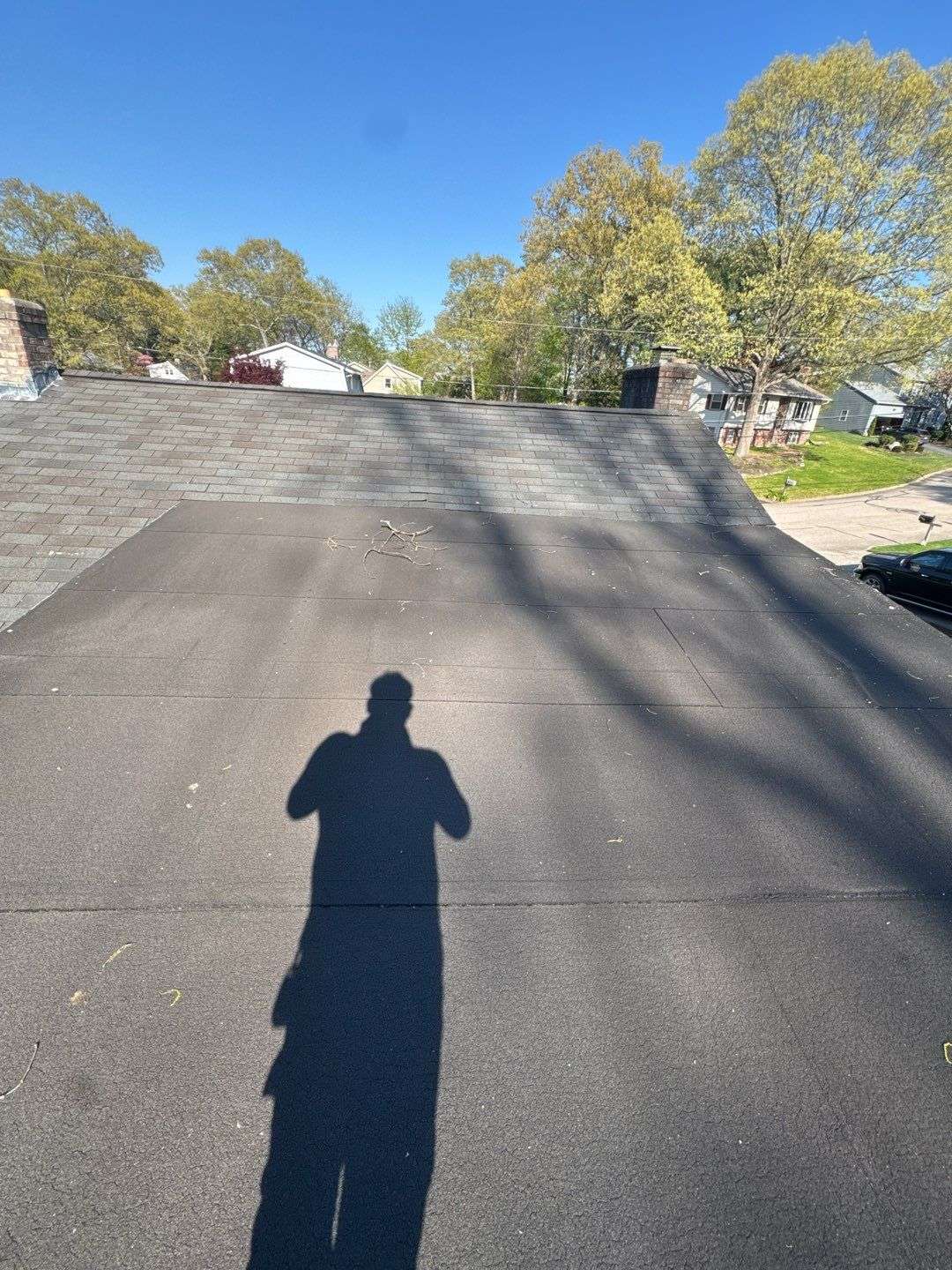 energy efficient roofing trends 2026 Modern energy-efficient residential roofing system installed in 2026 with flat roof membrane and asphalt shingles