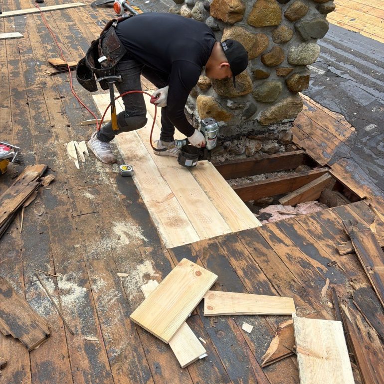 what happens during a professional roof inspection Professional roofer inspecting and repairing damaged roof decking during a residential roof inspection