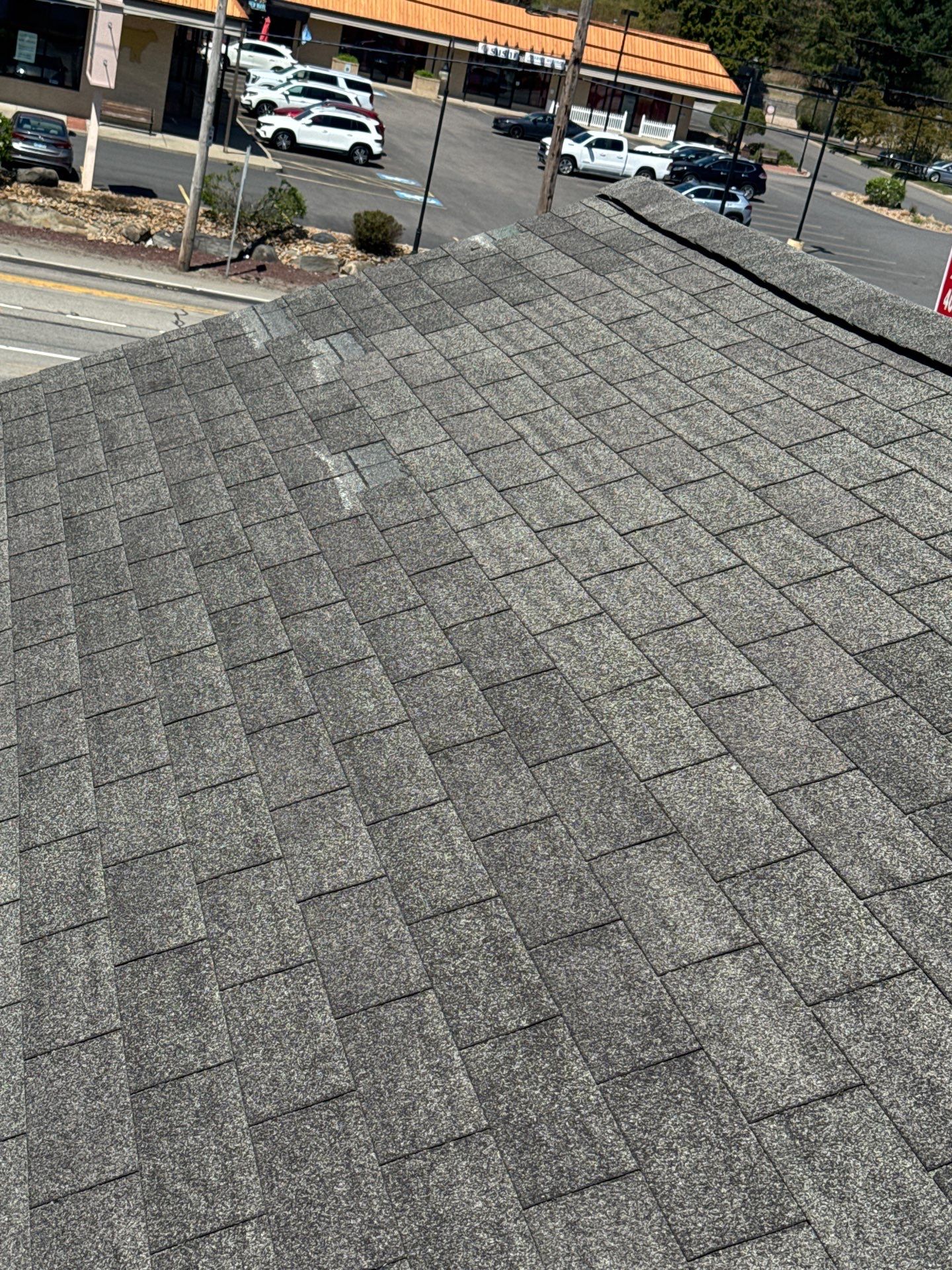 asphalt shingle roof inspection Close-up view of an asphalt shingle roof during a professional roof inspection by RHODY Ridge Roofing.