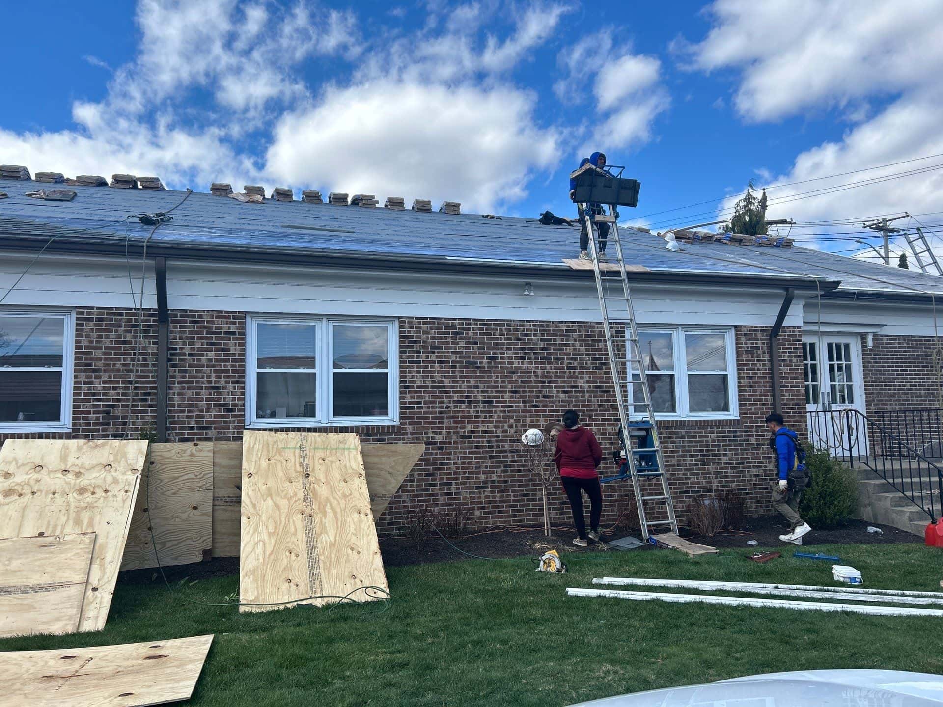 professional residential roofing service process Professional residential roofing service crew performing roof installation and repair work on a residential home.