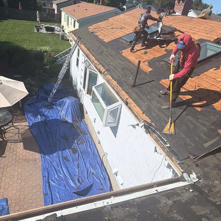 roof deck replacement before installing new shingles Roofing contractors replacing damaged roof decking before installing new asphalt shingles on a residential home.