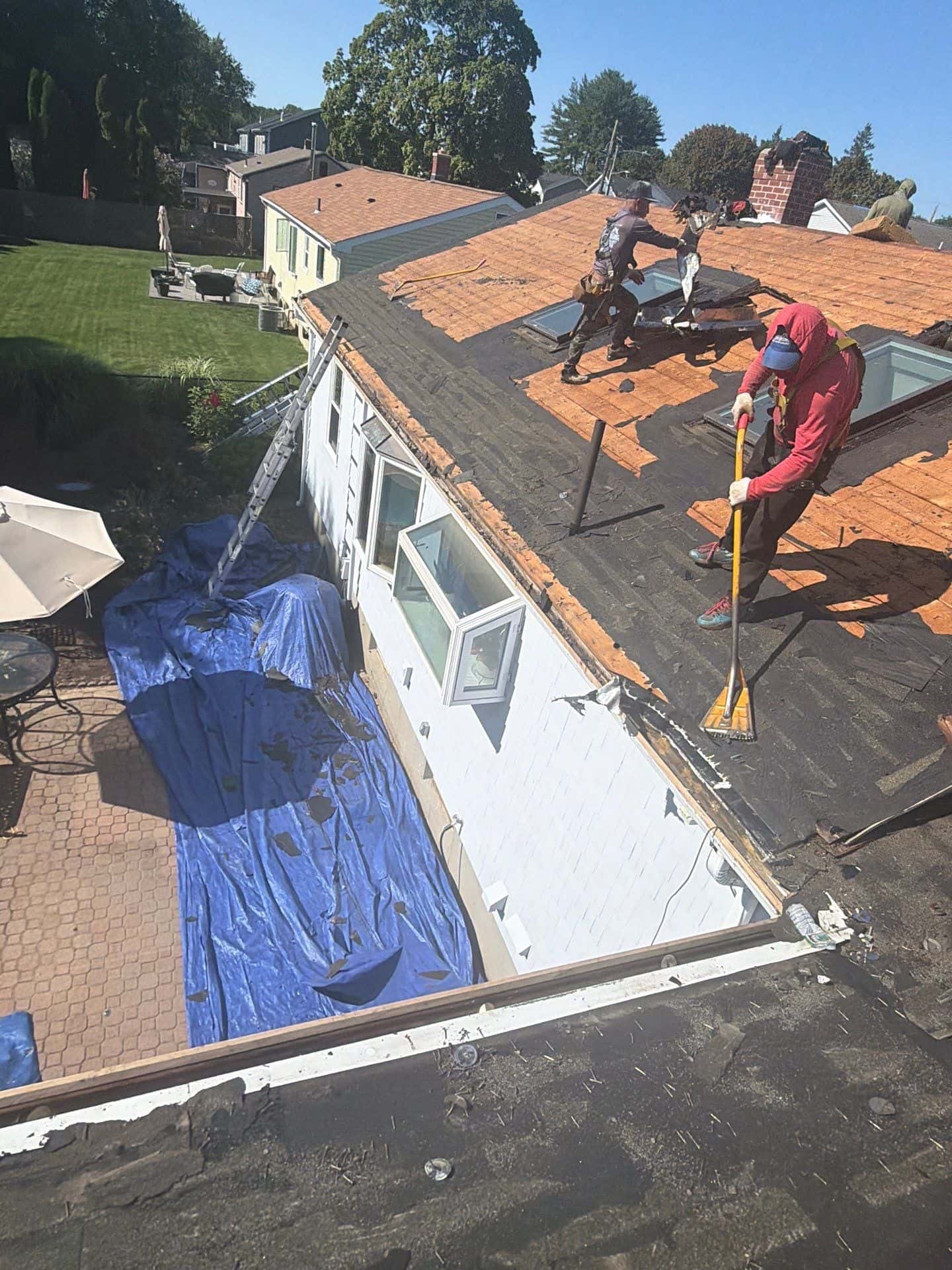 roof deck replacement before installing new shingles Roofing contractors replacing damaged roof decking before installing new asphalt shingles on a residential home.