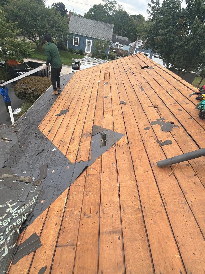 roof deck inspection after tear off Roof deck inspection after tear-off with exposed plywood decking on a residential roof